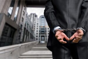 Man in suit in handcuffs - Pleasanton white collar defense lawyers Mirador Law